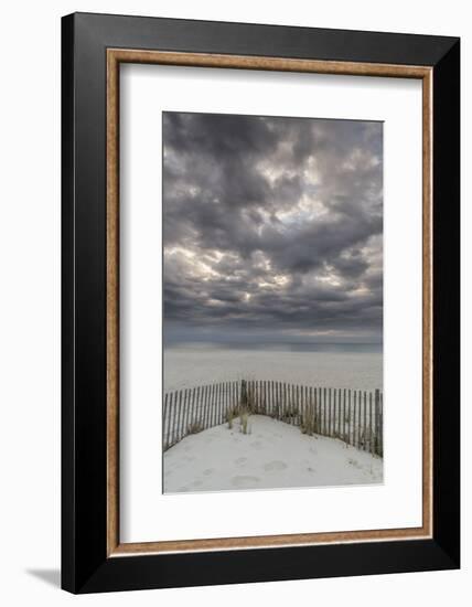 USA, New Jersey, Cape May National Seashore. Beach fence and stormy sunrise.-Jaynes Gallery-Framed Photographic Print