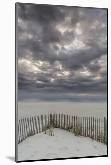 USA, New Jersey, Cape May National Seashore. Beach fence and stormy sunrise.-Jaynes Gallery-Mounted Photographic Print