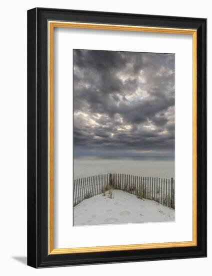 USA, New Jersey, Cape May National Seashore. Beach fence and stormy sunrise.-Jaynes Gallery-Framed Photographic Print