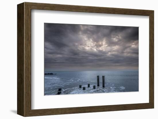 USA, New Jersey, Cape May National Seashore. Beach pilings on stormy sunrise.-Jaynes Gallery-Framed Photographic Print