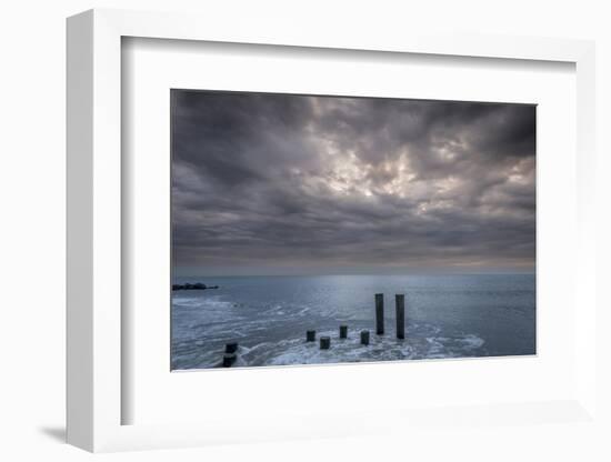 USA, New Jersey, Cape May National Seashore. Beach pilings on stormy sunrise.-Jaynes Gallery-Framed Photographic Print