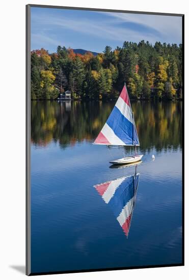 USA, New York, Adirondack Mountains, Lake Placid, Mirror Lake with sailboat, autumn-Walter Bibikow-Mounted Photographic Print