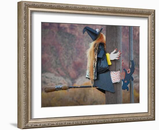 USA, Utah, Moab, Halloween witch on broomstick that crashed into pole.-Merrill Images-Framed Photographic Print