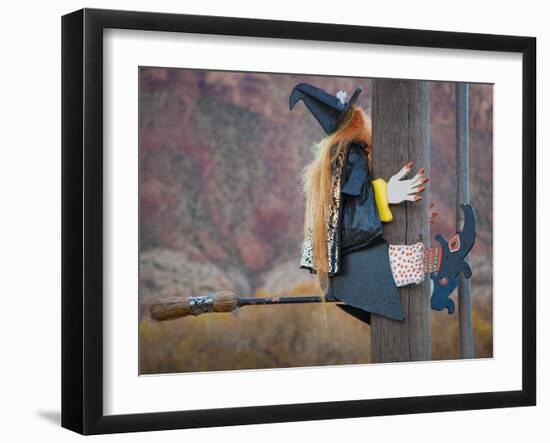 USA, Utah, Moab, Halloween witch on broomstick that crashed into pole.-Merrill Images-Framed Photographic Print