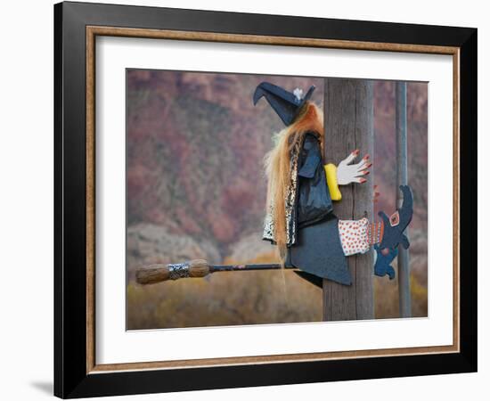 USA, Utah, Moab, Halloween witch on broomstick that crashed into pole.-Merrill Images-Framed Photographic Print