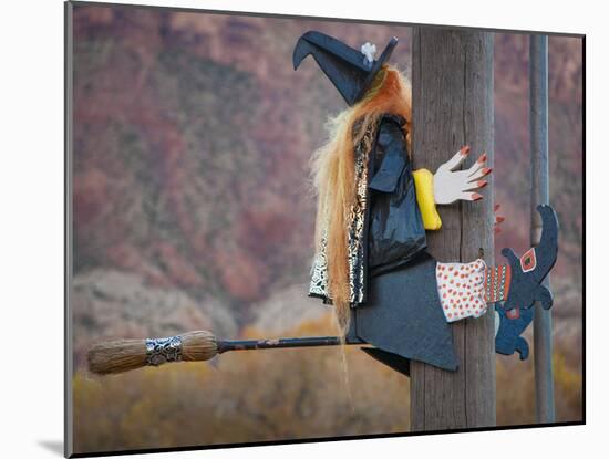 USA, Utah, Moab, Halloween witch on broomstick that crashed into pole.-Merrill Images-Mounted Photographic Print