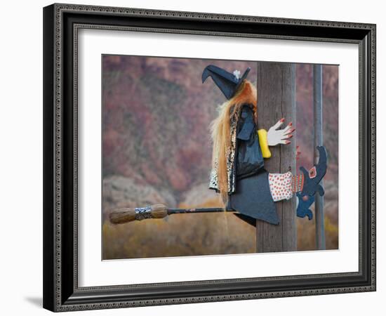 USA, Utah, Moab, Halloween witch on broomstick that crashed into pole.-Merrill Images-Framed Photographic Print