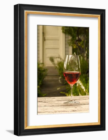 USA, Washington, Prosser. A glass of red wine on a picnic table outside of eastern Washington-Richard Duval-Framed Photographic Print