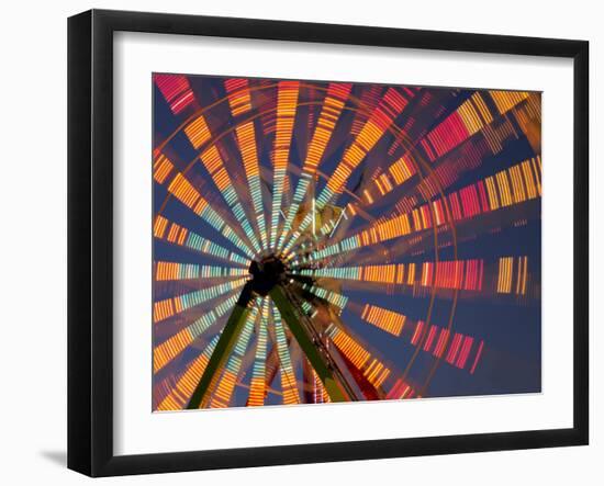 USA, Washington State, Puyallup, ferris wheel in motion at annual Puyallup Fair at night.-Merrill Images-Framed Photographic Print