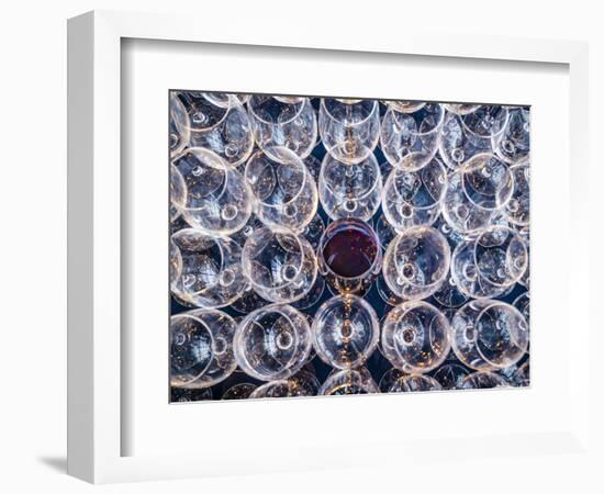 USA, Washington State, Seattle. One glass of red wine in a row of wine glasses.-Richard Duval-Framed Photographic Print