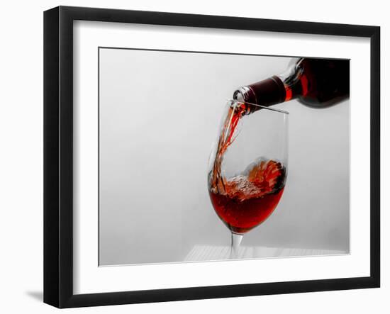 USA, Washington State, Seattle. Red wine pours into a glass.-Richard Duval-Framed Photographic Print