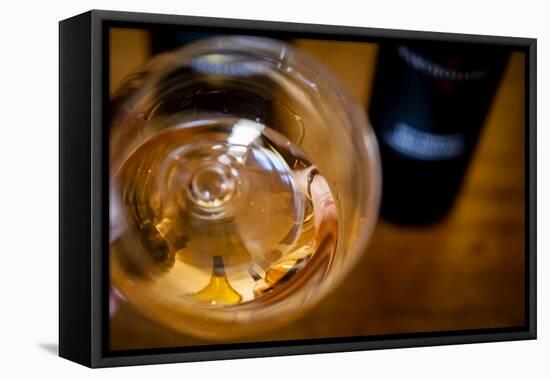 USA, Washington State, Seattle. Wine bottles are reflected in a glass of L'Orange, a Pinot Gris mad-Richard Duval-Framed Premier Image Canvas