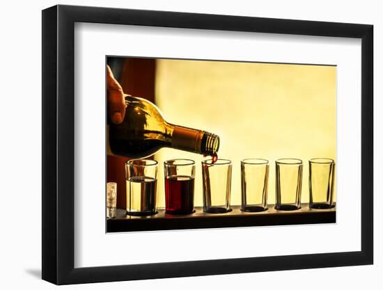 USA, Washington, Walla Walla. Man prepares a flight of white and red wine for sample tasting-Richard Duval-Framed Photographic Print