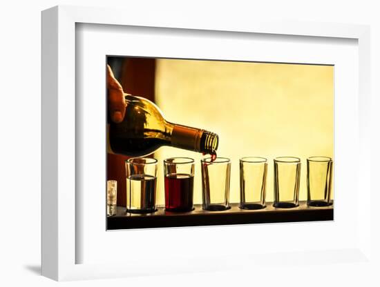 USA, Washington, Walla Walla. Man prepares a flight of white and red wine for sample tasting-Richard Duval-Framed Photographic Print