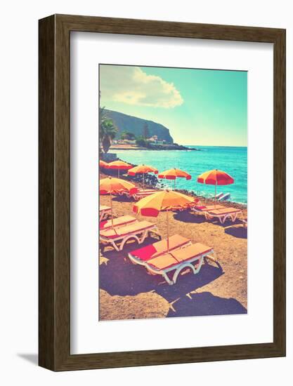 Vacant Umbrellas and Chaise Longues on a Sea Beach, Tenerife. Retro Style Filtered Image-Zoom-zoom-Framed Photographic Print