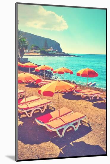 Vacant Umbrellas and Chaise Longues on a Sea Beach, Tenerife. Retro Style Filtered Image-Zoom-zoom-Mounted Photographic Print