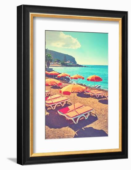 Vacant Umbrellas and Chaise Longues on a Sea Beach, Tenerife. Retro Style Filtered Image-Zoom-zoom-Framed Photographic Print