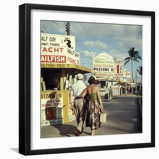 Vacationers Walking by Booths Advertising Boat Tours-Hank Walker-Framed Photographic Print