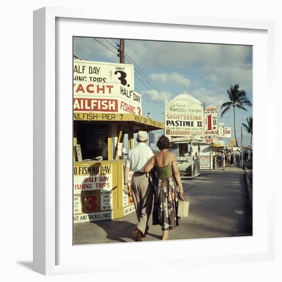 Vacationers Walking by Booths Advertising Boat Tours-Hank Walker-Framed Photographic Print