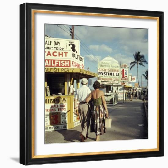 Vacationers Walking by Booths Advertising Boat Tours-Hank Walker-Framed Photographic Print