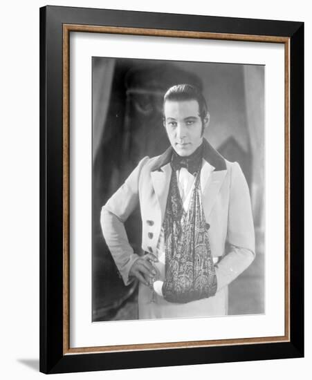 Valentino on the set of 'The Eagle' with his arm in a sling after a car accident, c.1925-null-Framed Photographic Print
