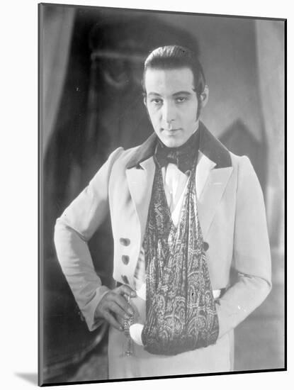 Valentino on the set of 'The Eagle' with his arm in a sling after a car accident, c.1925-null-Mounted Photographic Print
