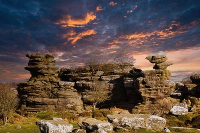 Sunset Brimham Rocks Dramatic sky at sunset over rugged rock formations in a serene ...