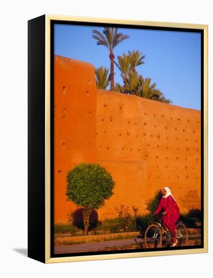 Veiled Woman Bicycling Below Red City Walls, Marrakech, Morocco-Merrill Images-Framed Premier Image Canvas
