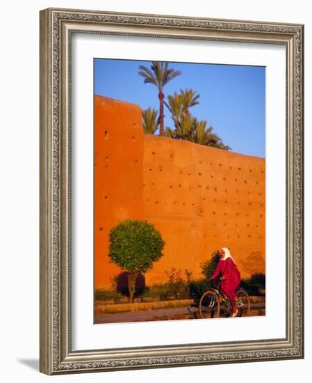 Veiled Woman Bicycling Below Red City Walls, Marrakech, Morocco-Merrill Images-Framed Photographic Print