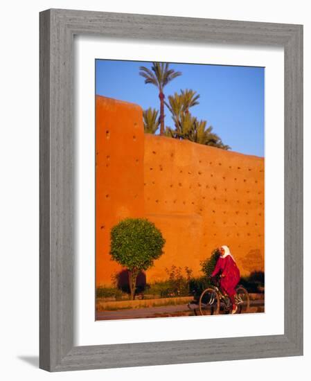 Veiled Woman Bicycling Below Red City Walls, Marrakech, Morocco-Merrill Images-Framed Photographic Print