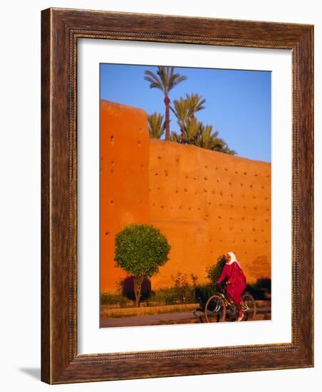 Veiled Woman Bicycling Below Red City Walls, Marrakech, Morocco-Merrill Images-Framed Photographic Print