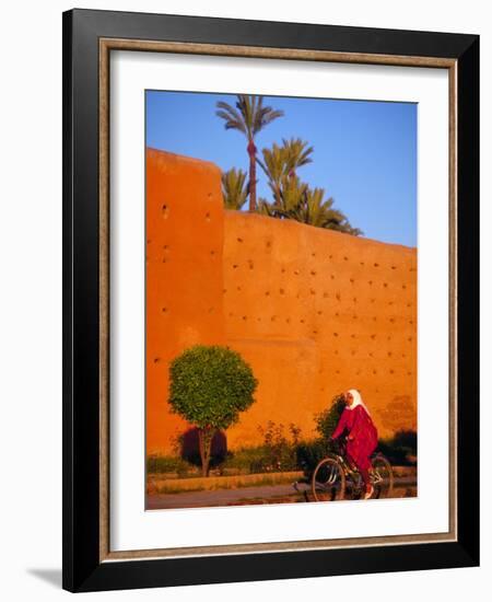 Veiled Woman Bicycling Below Red City Walls, Marrakech, Morocco-Merrill Images-Framed Photographic Print