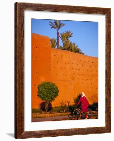 Veiled Woman Bicycling Below Red City Walls, Marrakech, Morocco-Merrill Images-Framed Photographic Print