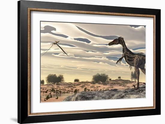 Velociraptor Dinosaur Observing a Pteranodon Flying over the Desert-Stocktrek Images-Framed Art Print