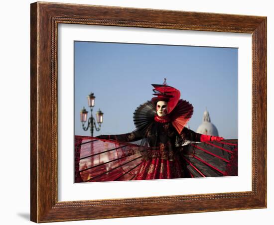 Venice, Veneto, Italy, a Mask in Costume on the Bacino Di San Marco with the Cupola of Santa Maria -Ken Scicluna-Framed Photographic Print