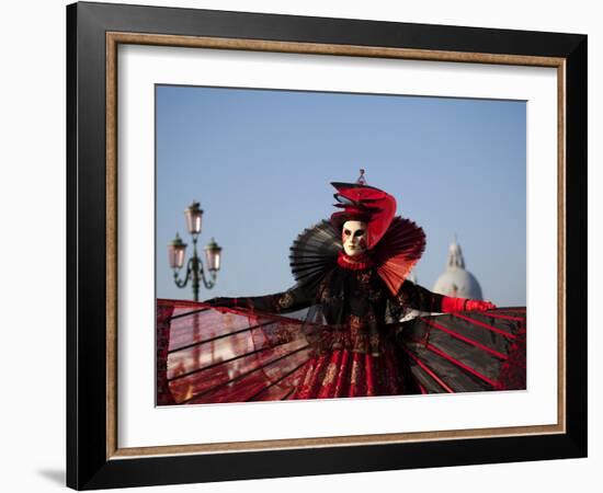 Venice, Veneto, Italy, a Mask in Costume on the Bacino Di San Marco with the Cupola of Santa Maria -Ken Scicluna-Framed Photographic Print