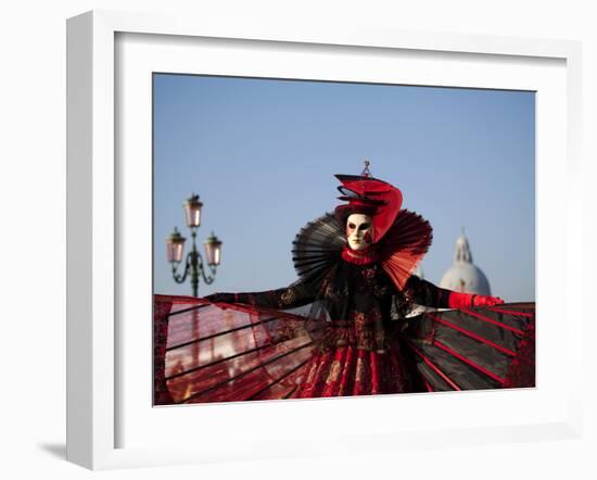 Venice, Veneto, Italy, a Mask in Costume on the Bacino Di San Marco with the Cupola of Santa Maria -Ken Scicluna-Framed Photographic Print