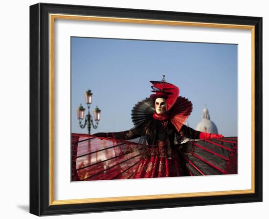 Venice, Veneto, Italy, a Mask in Costume on the Bacino Di San Marco with the Cupola of Santa Maria -Ken Scicluna-Framed Photographic Print