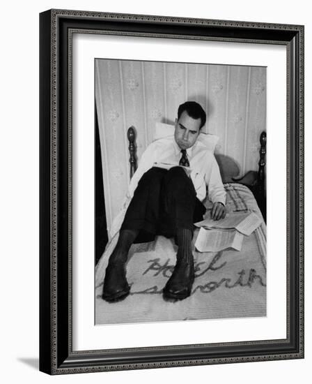 Vice Presidential Candidate Richard M. Nixon Sitting on His Hotel Bed Reviewing Paperwork-Cornell Capa-Framed Photographic Print