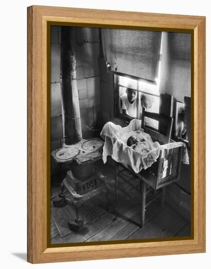 Victoria Cooper's Children Peering in Window Where Newborn Baby Lies in Crib Made from Fruit Crate-W^ Eugene Smith-Framed Premier Image Canvas