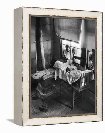 Victoria Cooper's Children Peering in Window Where Newborn Baby Lies in Crib Made from Fruit Crate-W^ Eugene Smith-Framed Premier Image Canvas