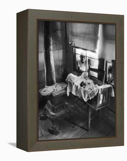 Victoria Cooper's Children Peering in Window Where Newborn Baby Lies in Crib Made from Fruit Crate-W^ Eugene Smith-Framed Premier Image Canvas