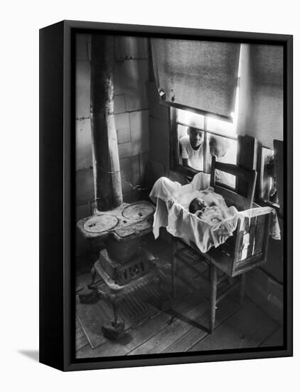 Victoria Cooper's Children Peering in Window Where Newborn Baby Lies in Crib Made from Fruit Crate-W^ Eugene Smith-Framed Premier Image Canvas