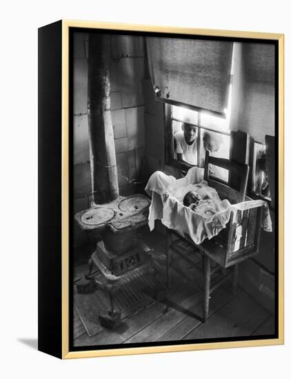 Victoria Cooper's Children Peering in Window Where Newborn Baby Lies in Crib Made from Fruit Crate-W^ Eugene Smith-Framed Premier Image Canvas