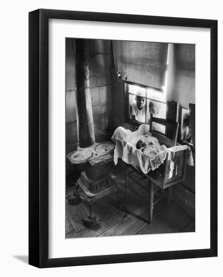 Victoria Cooper's Children Peering in Window Where Newborn Baby Lies in Crib Made from Fruit Crate-W^ Eugene Smith-Framed Photographic Print