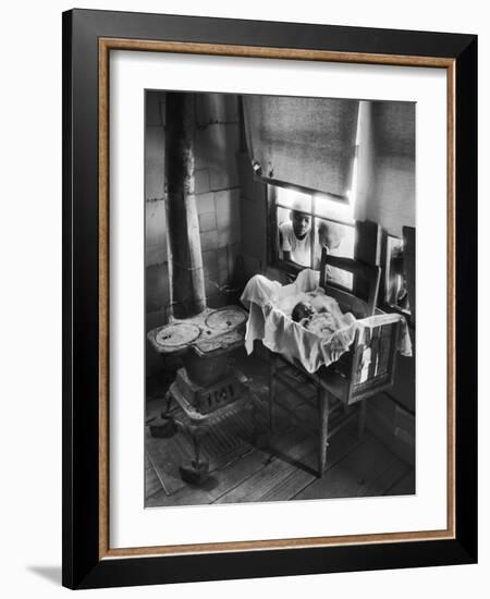 Victoria Cooper's Children Peering in Window Where Newborn Baby Lies in Crib Made from Fruit Crate-W^ Eugene Smith-Framed Photographic Print