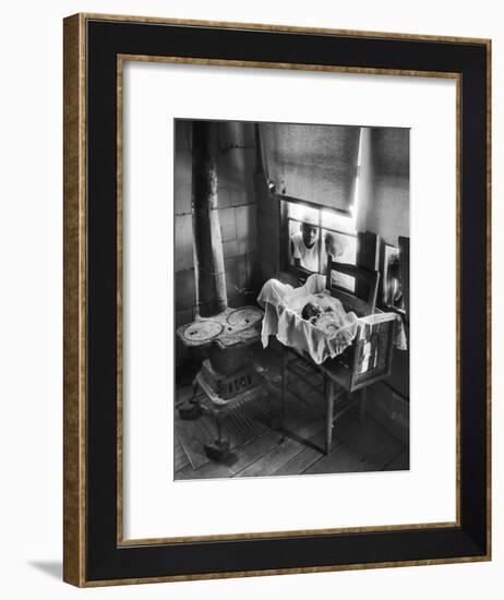 Victoria Cooper's Children Peering in Window Where Newborn Baby Lies in Crib Made from Fruit Crate-W^ Eugene Smith-Framed Photographic Print