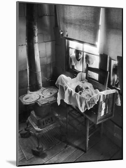 Victoria Cooper's Children Peering in Window Where Newborn Baby Lies in Crib Made from Fruit Crate-W^ Eugene Smith-Mounted Photographic Print