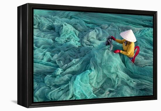 Vietnam. Fishing net analysis and repair with old fashioned manual sowing machine.-Tom Norring-Framed Premier Image Canvas