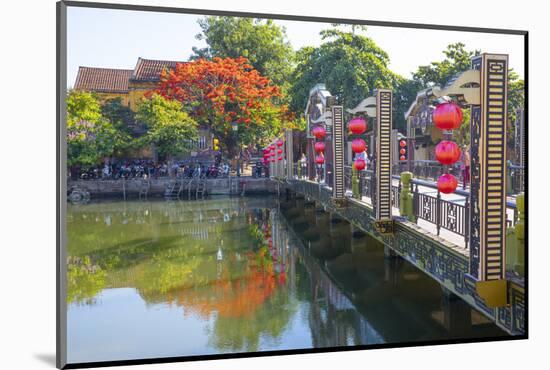 Vietnam. Hoi An bridge over the river with reflections and silk lamps.-Tom Norring-Mounted Photographic Print